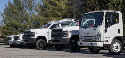 fleet of different commercial trucks in a row